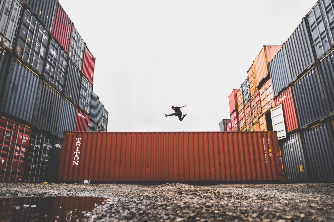 A man jumping on a intermodal container